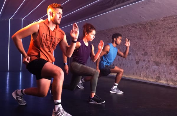 A group of people unwinding after a yoga class in a studio gym