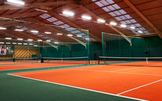 The expansive multi-court indoor tennis space at the club