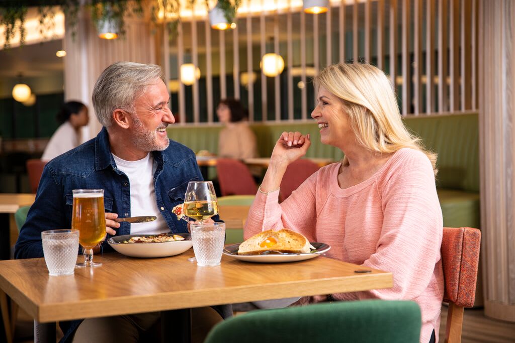 Friends enjoying a drink in Raynes Park social spaces