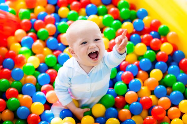 Baby playing in a ball pit