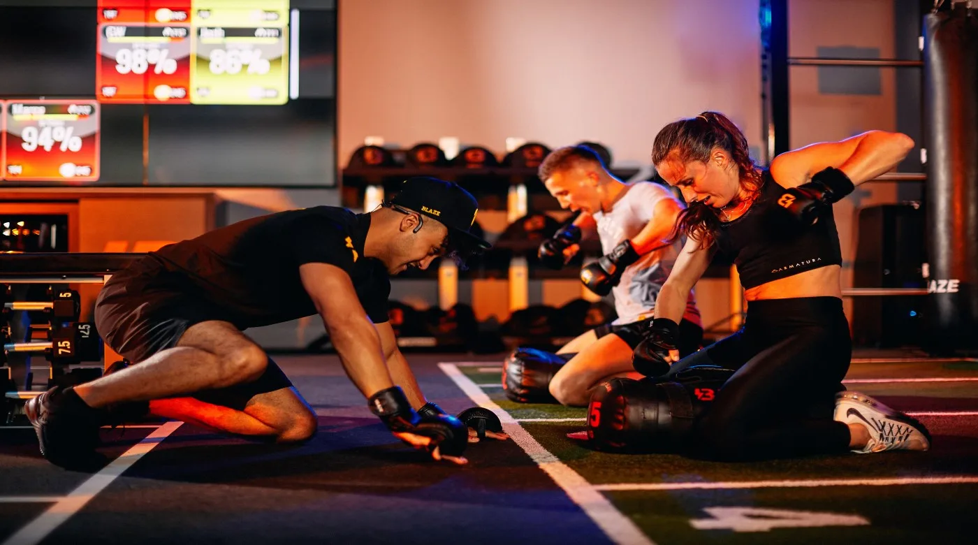 Woman and man lifting weights in the Blaze HIIT class at David Lloyd