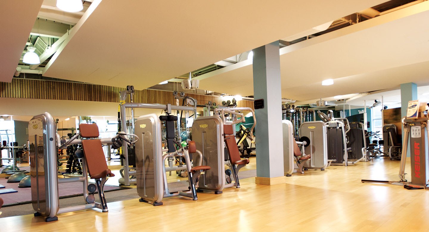 Woman using the Battleropes on the sled track at a David Lloyd gym