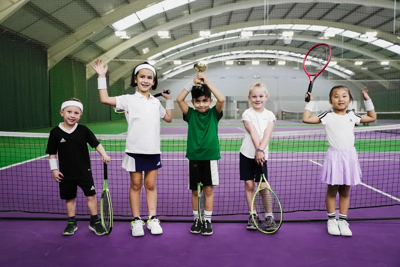 Kids playing on a tennis court