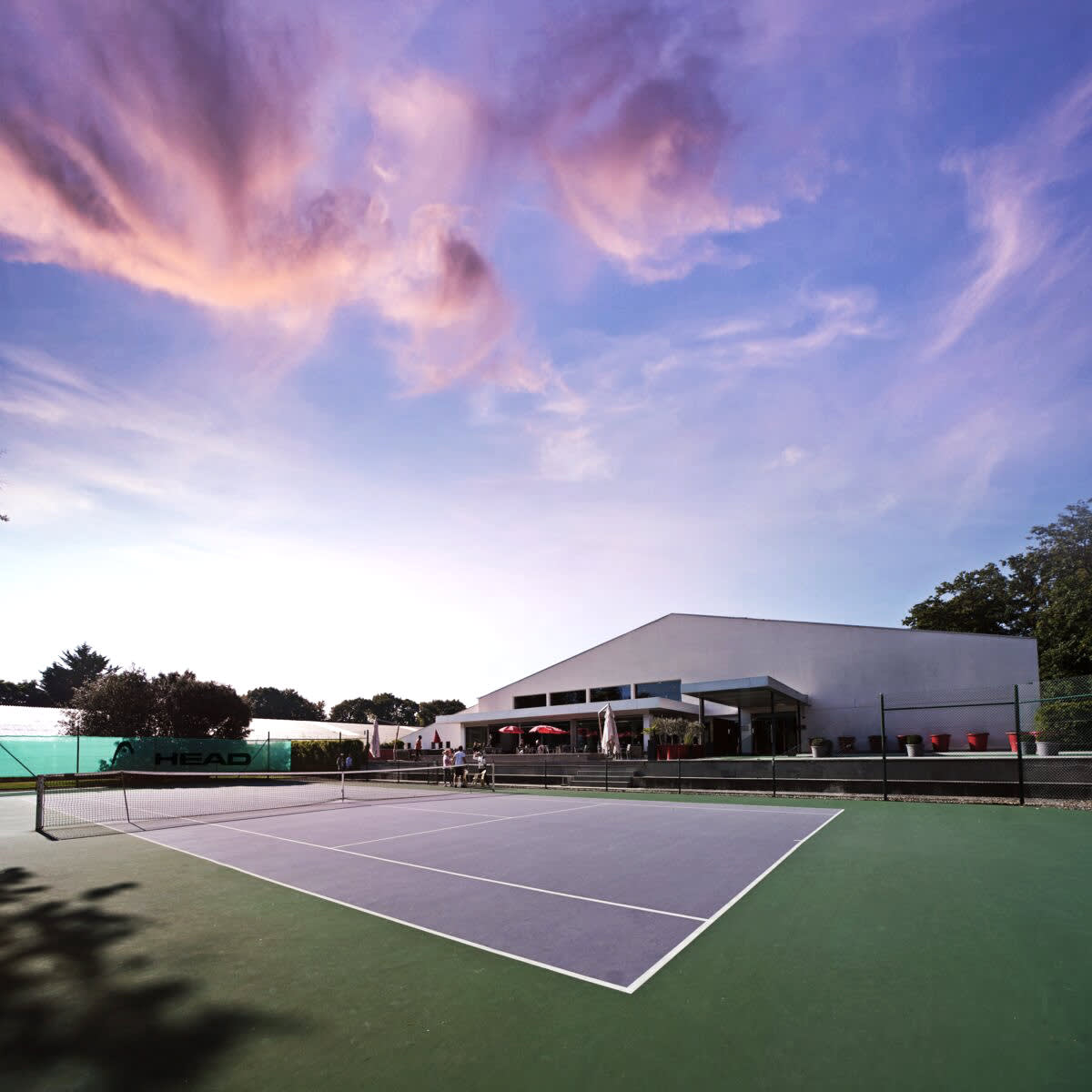 A tennis court and sunset