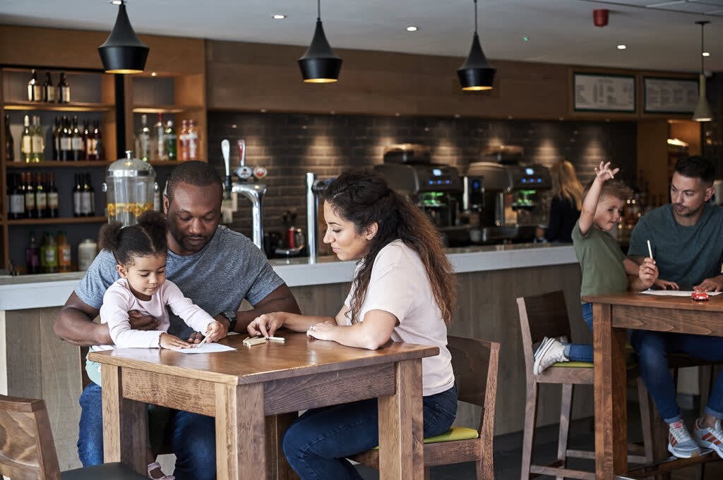 Family enjoying time together in a David Lloyd Clubs Clubroom