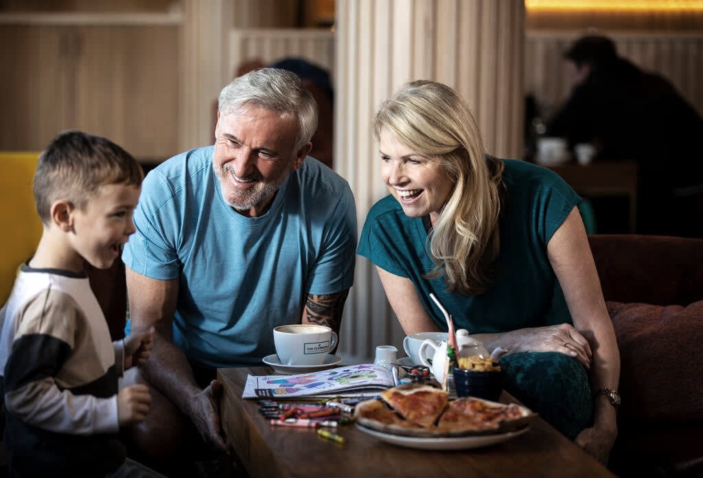 Family sit together in the Clubroom at David Lloyd Clubs