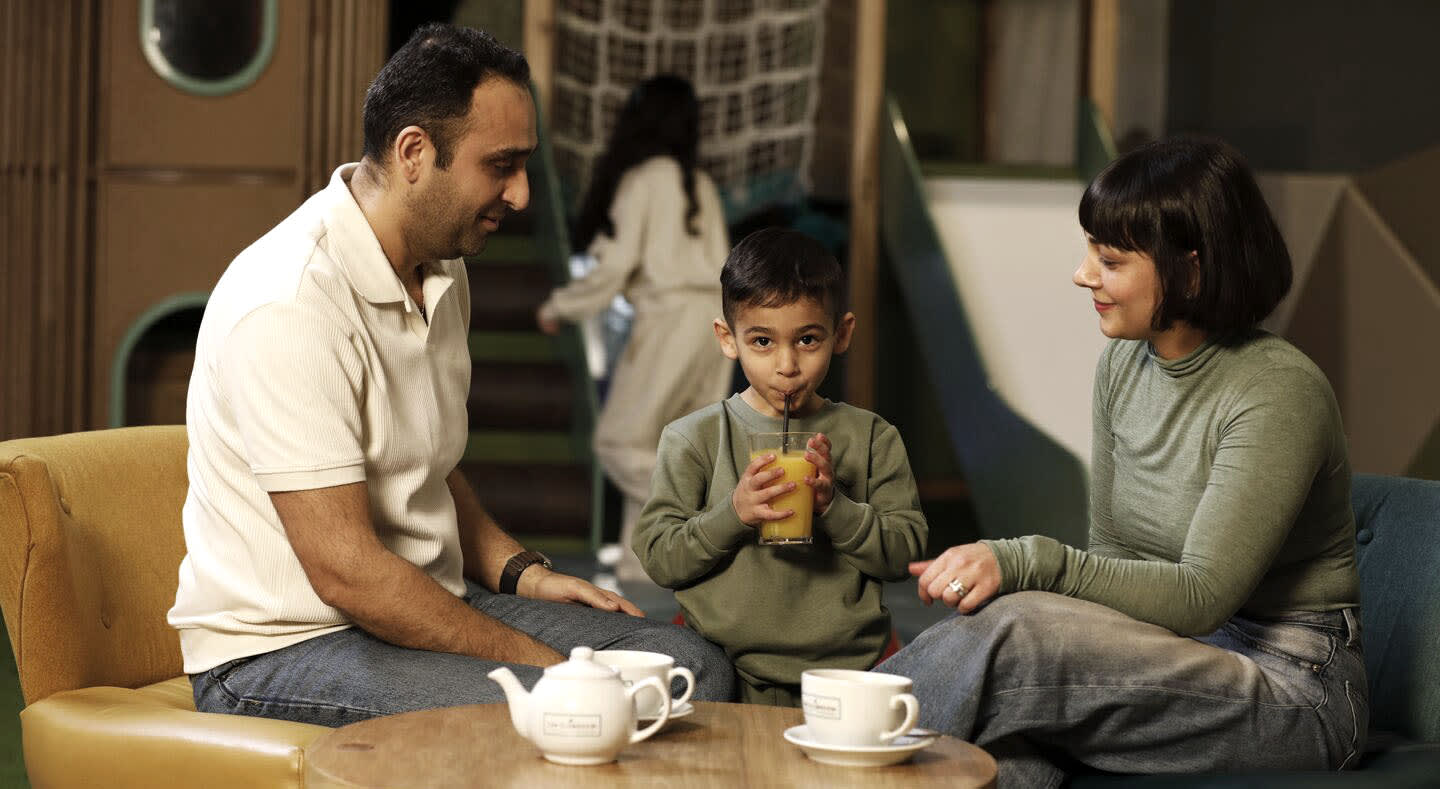 A family enjoys a drink together