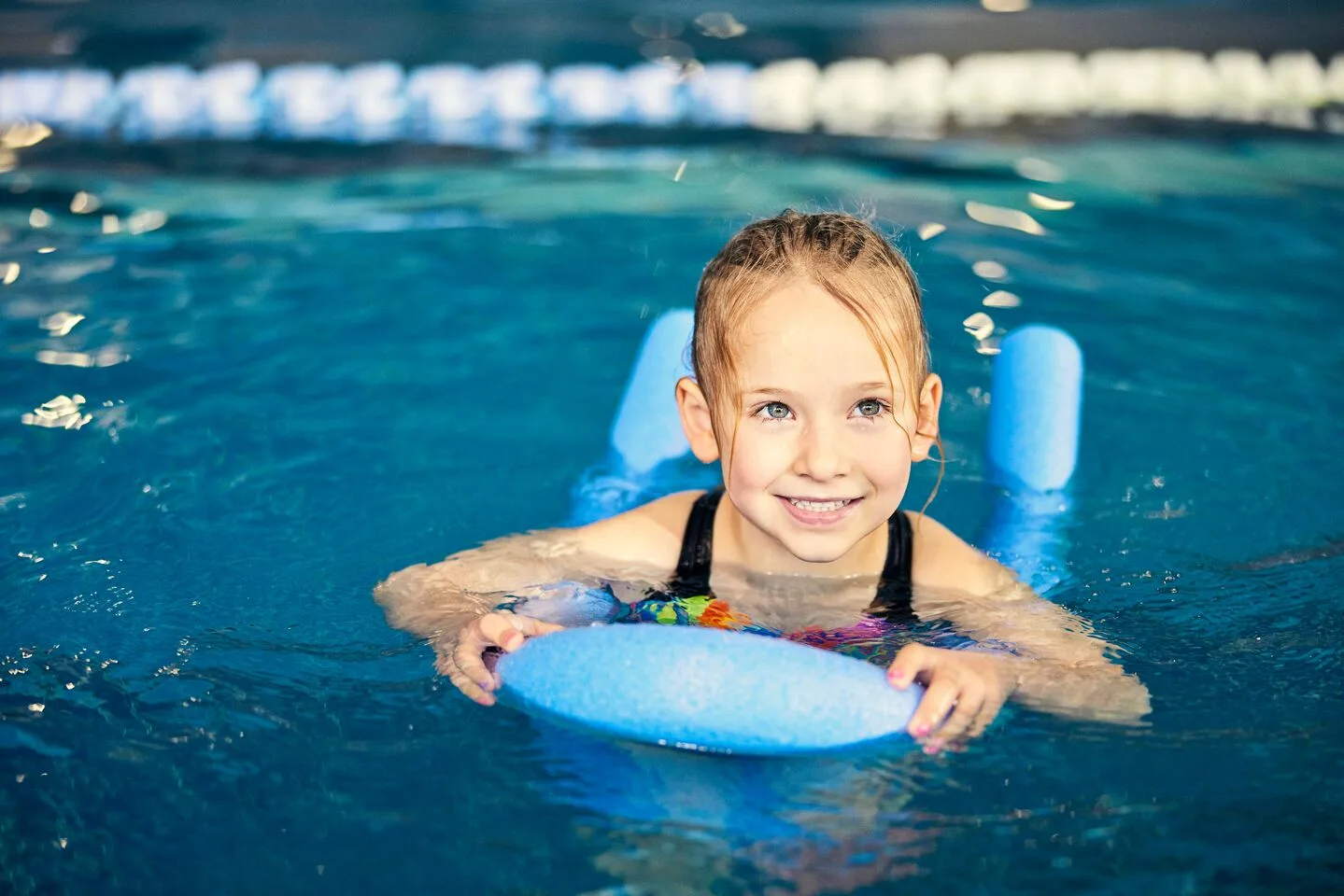 Girl swimming with a woggle