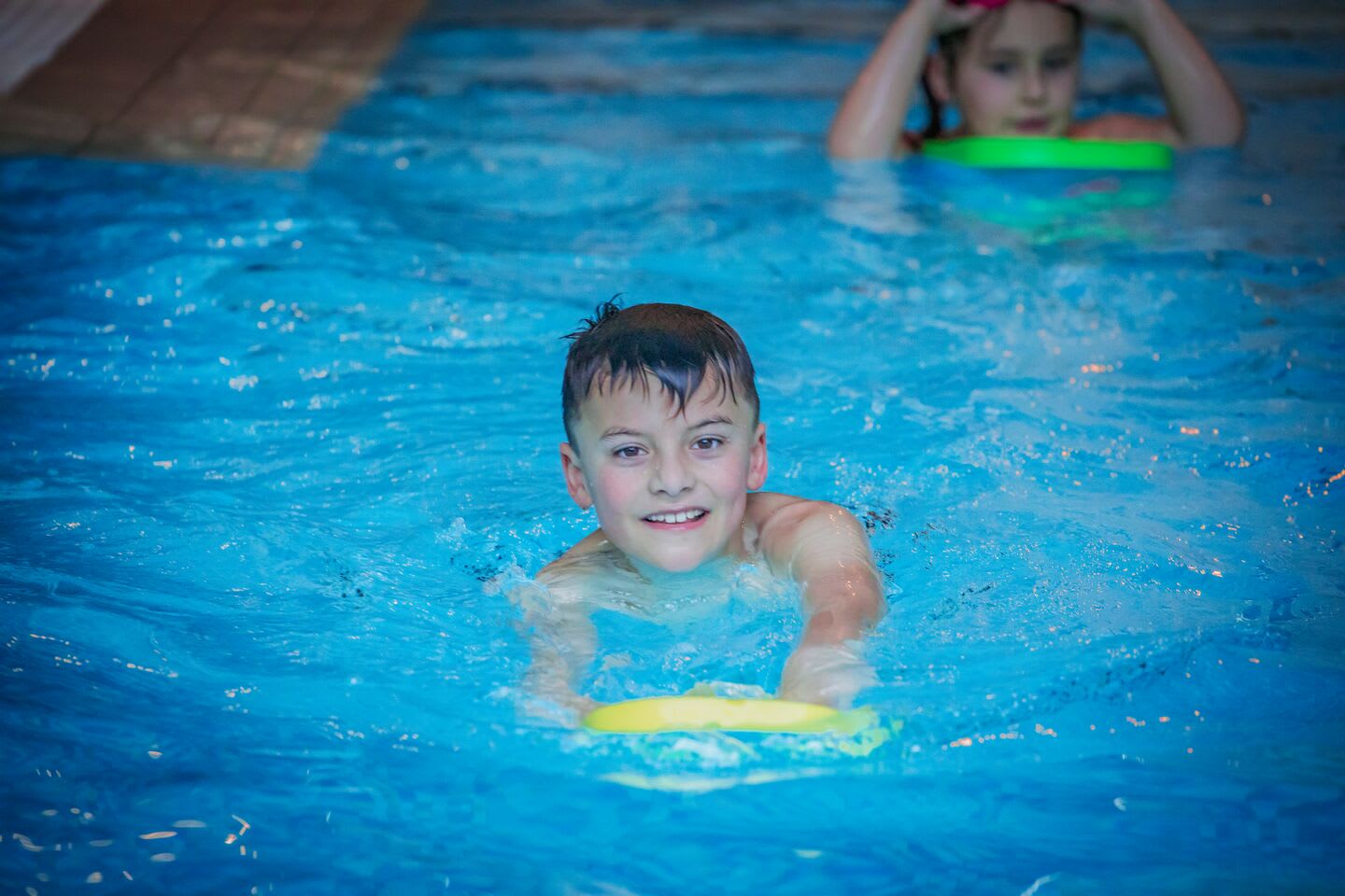 Boy swimming with a float