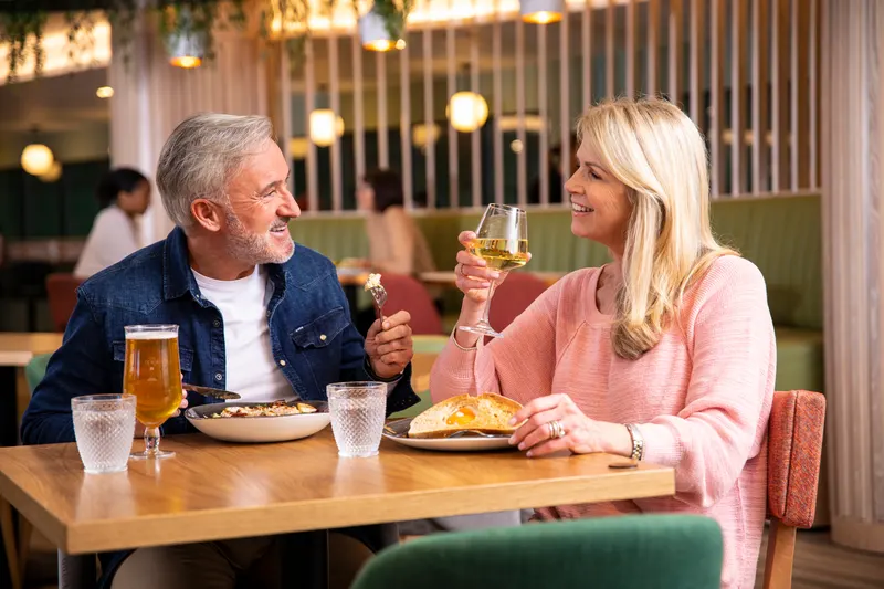 Couple enjoying food and drinks