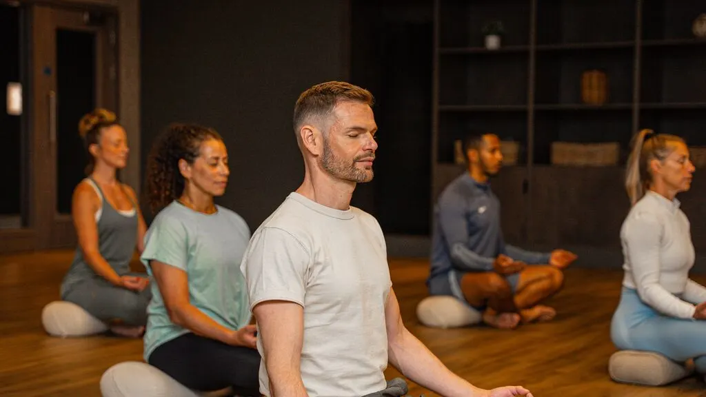 People meditating in a yoga class.