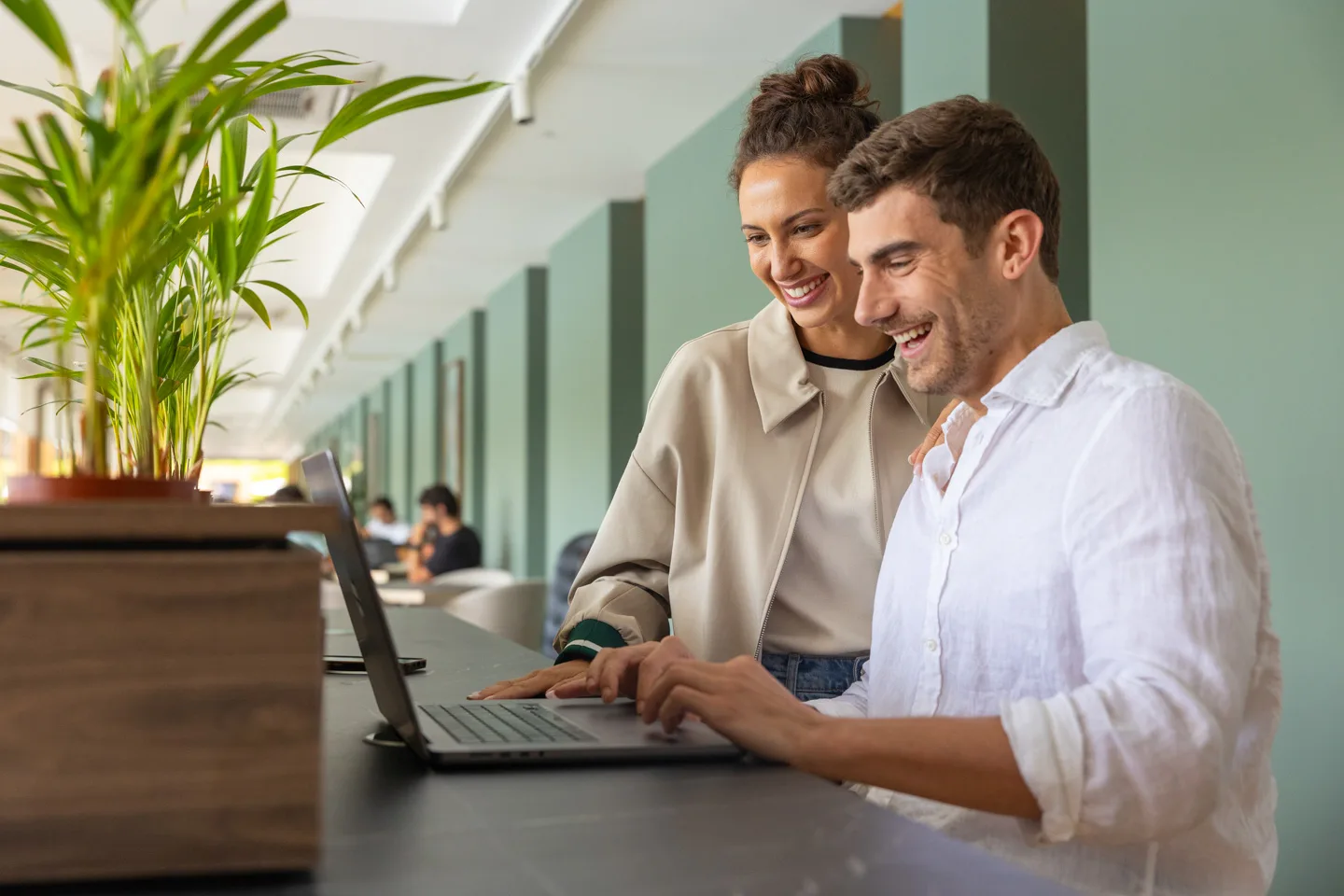 A man and a woman looking at a laptop